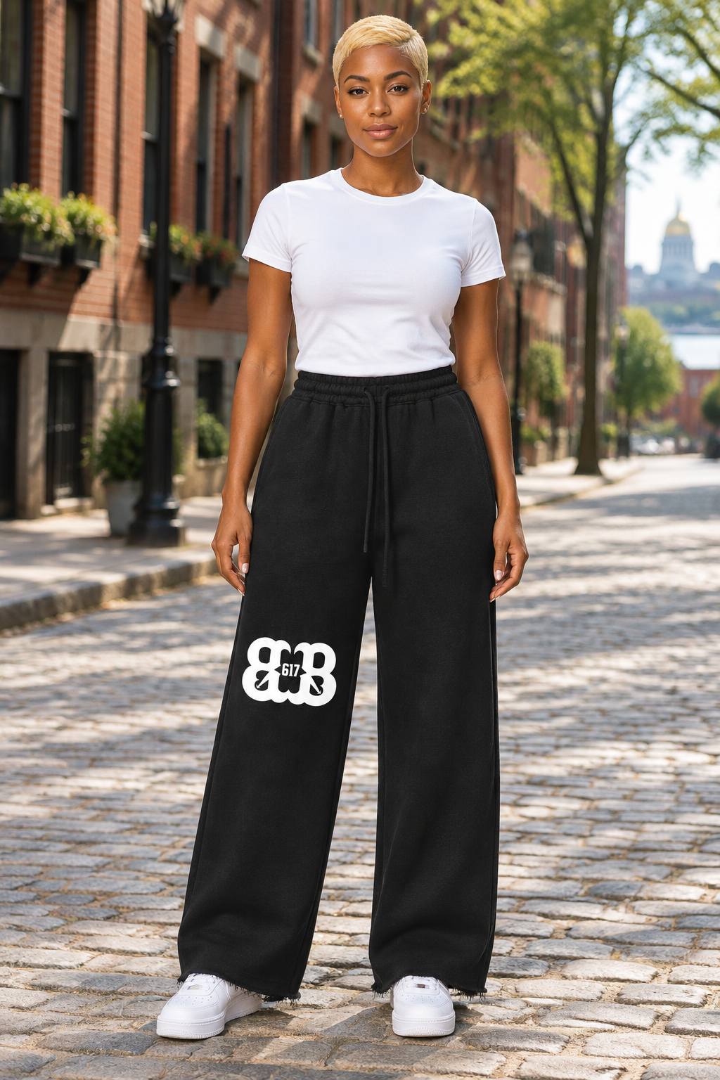 Fit African American female wearing black wide-leg raw-edge sweatpants