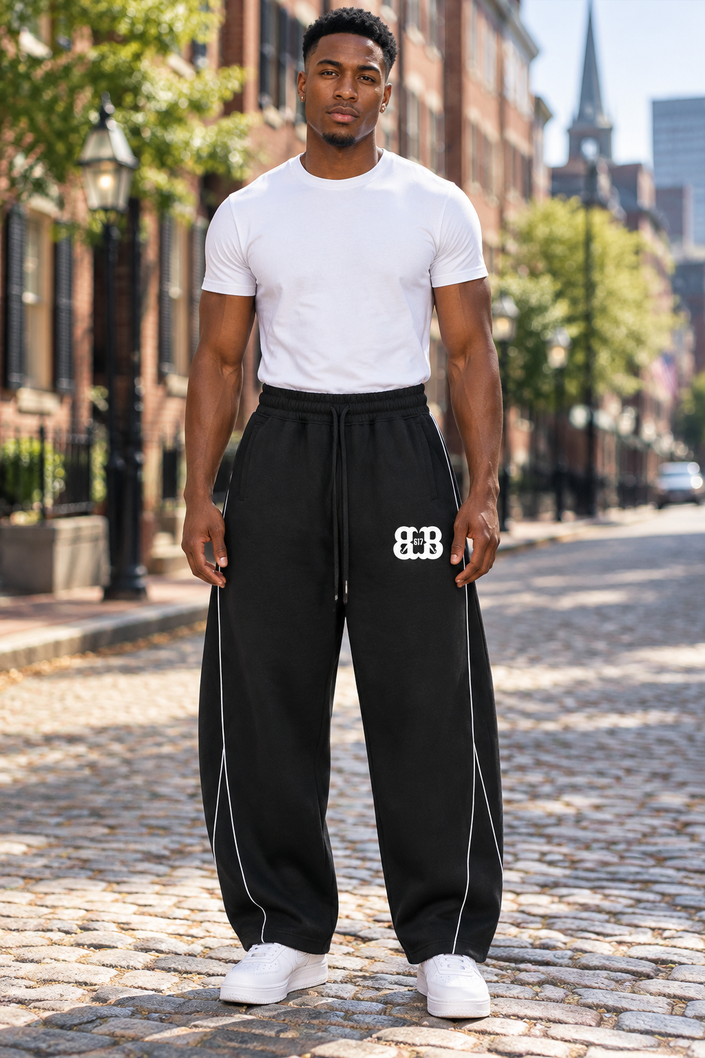 Fit African American male wearing black piping fleece barrel-leg sweatpants