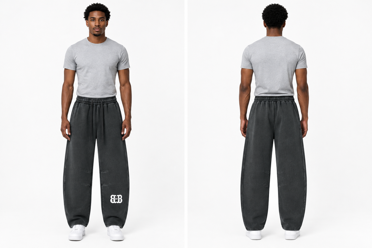 Front and back views of a fit Black male model wearing the Bred in Boston barrel-leg sweatpants