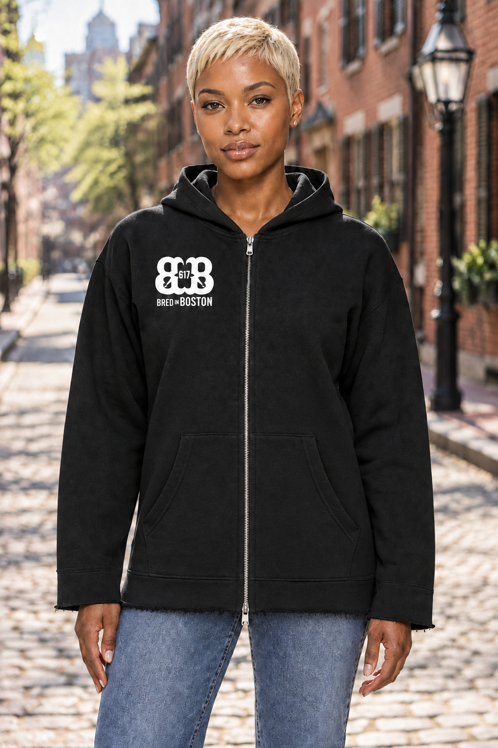 Model wearing a longer hip-length black hoodie